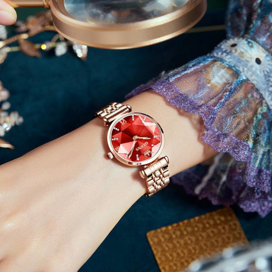 Rose gold luxury fashion watch with red dial and diamond accents